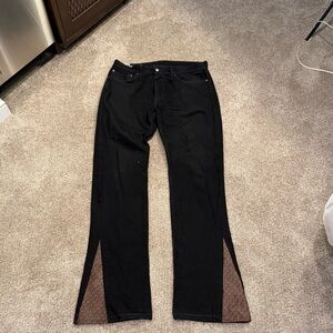 Men’s upcycled Black Levi’s 505 Jeans with Michael Kors logo on bottoms.